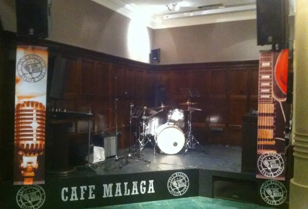 Intimate interior of Café Málaga with small live music stage and elegant modern décor