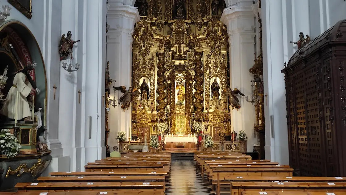 Baroque-neoclassical portal of the Iglesia de San Juan y Todos los Santos on Plaza de la Trinidad, Córdoba, with Solomonic columns framing a niche with an angel