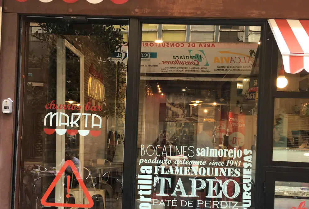 Churros and hot chocolate at a bar counter on Calle Cruz Conde in central Córdoba