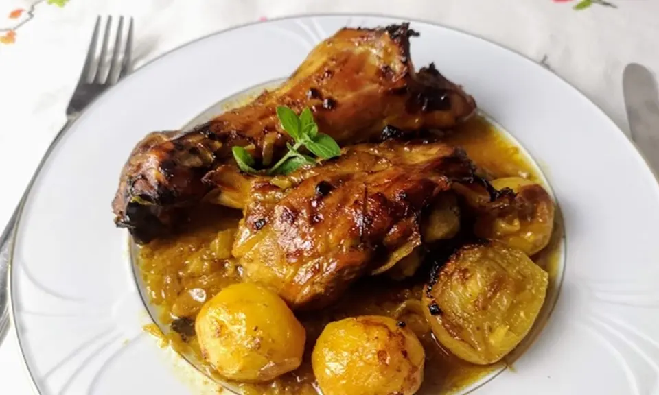 Slow-roasted honey lamb Córdoba style, cordero a la miel plated with potatoes and herbs