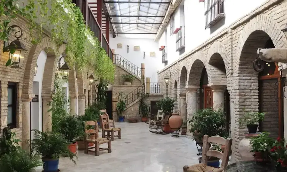 Verdant patio of Hacienda Posada de Vallina with fountain and plants