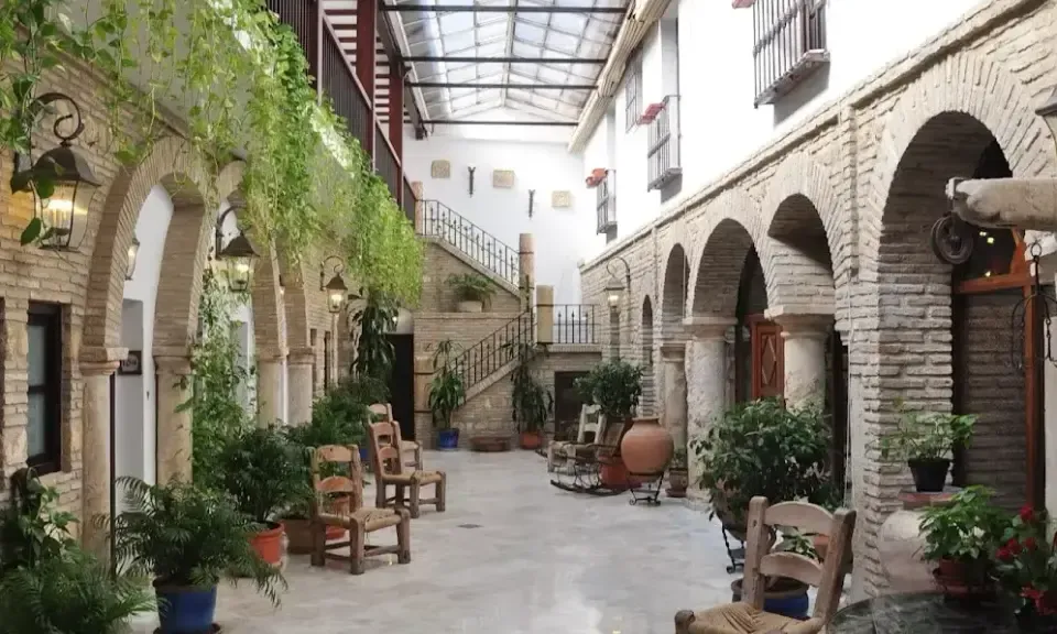 Verdant patio of Hacienda Posada de Vallina with fountain and plants