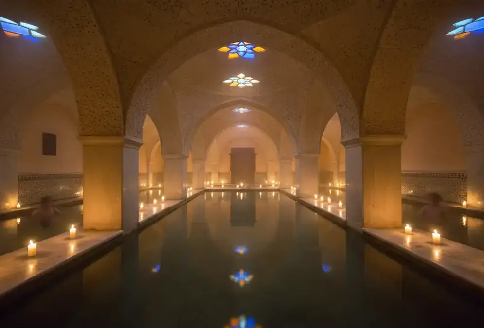 Interior of Hammam Al Ándalus with Moorish architecture, barrel vaulted ceilings and star-shaped stained glass