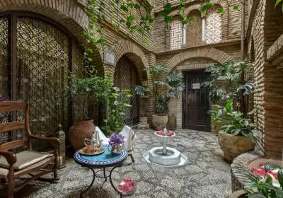 Interior of Hammam Al Ándalus with pools and vaulted ceilings lit by candlelight
