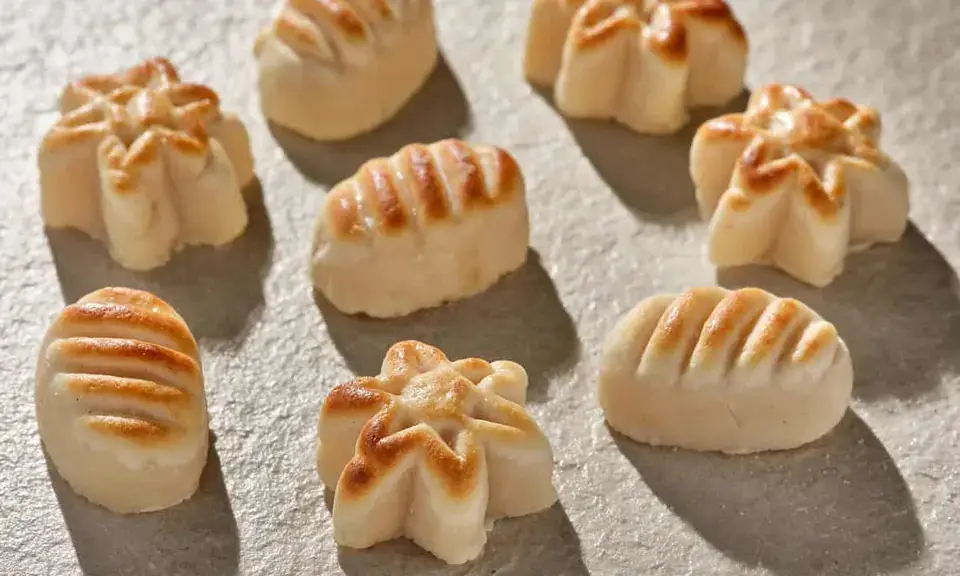 Golden mazapán de Córdoba figurines arranged on a traditional platter