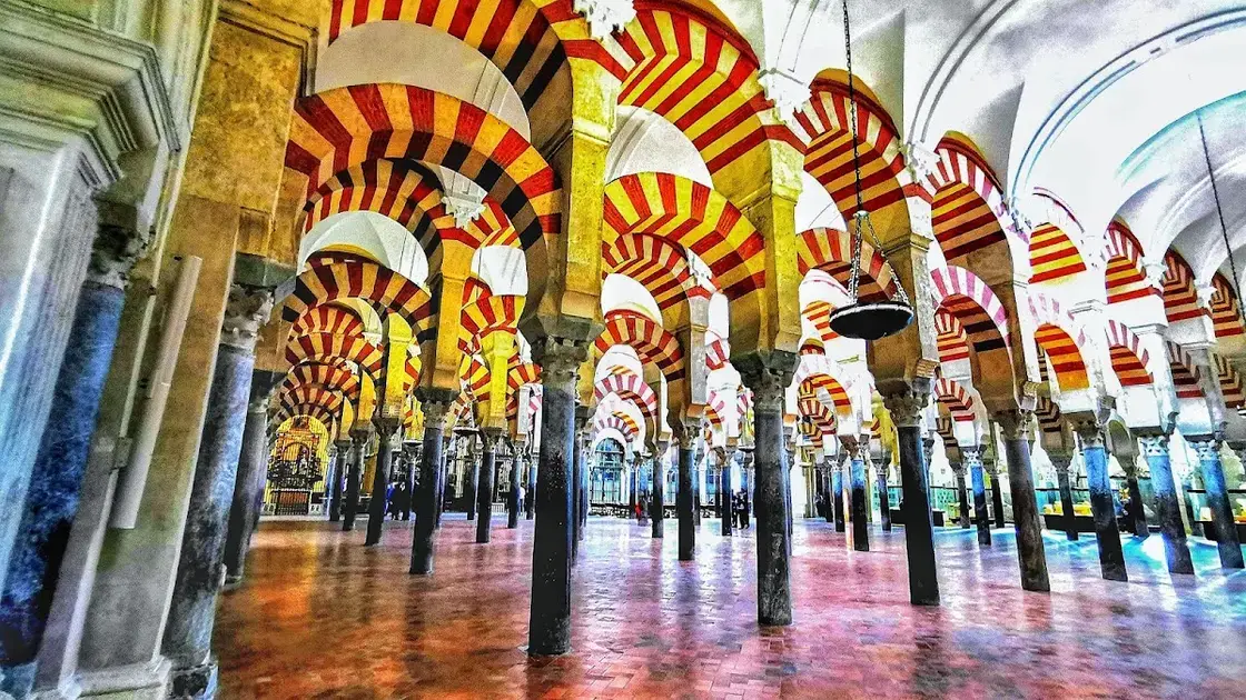 Interior of the Mezquita-Catedral de Córdoba with its iconic red-and-white arches and forest of columns