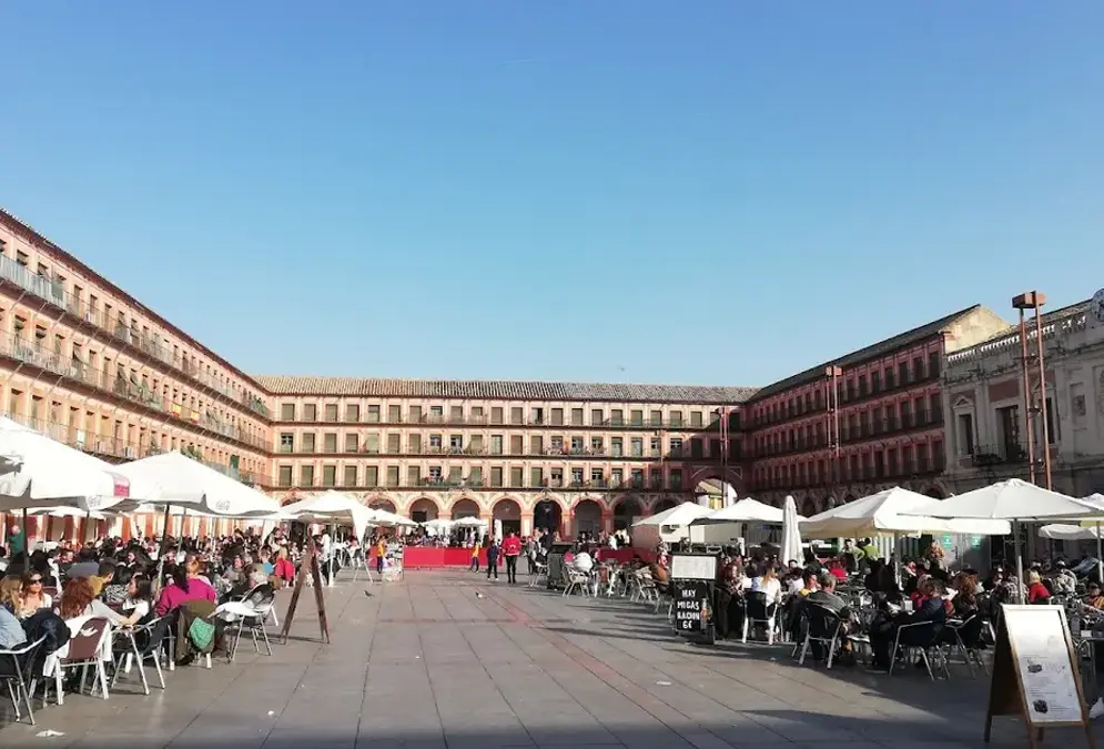 Plaza de la Corredera in Córdoba with its characteristic arcades and ochre facades