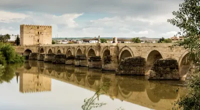 Puente Romano de Córdoba spanning the Guadalquivir with the Mezquita in the background