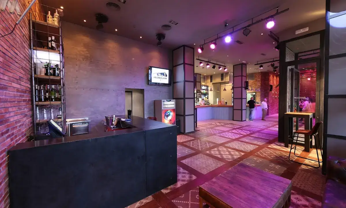 Packed dance floor at Sala Hangar with DJ lighting and a festive crowd