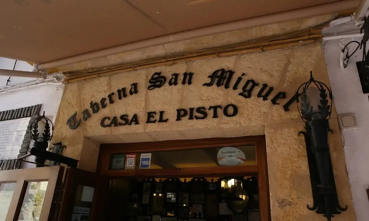 Authentic interior of Taberna San Miguel with traditional counter and local clientele